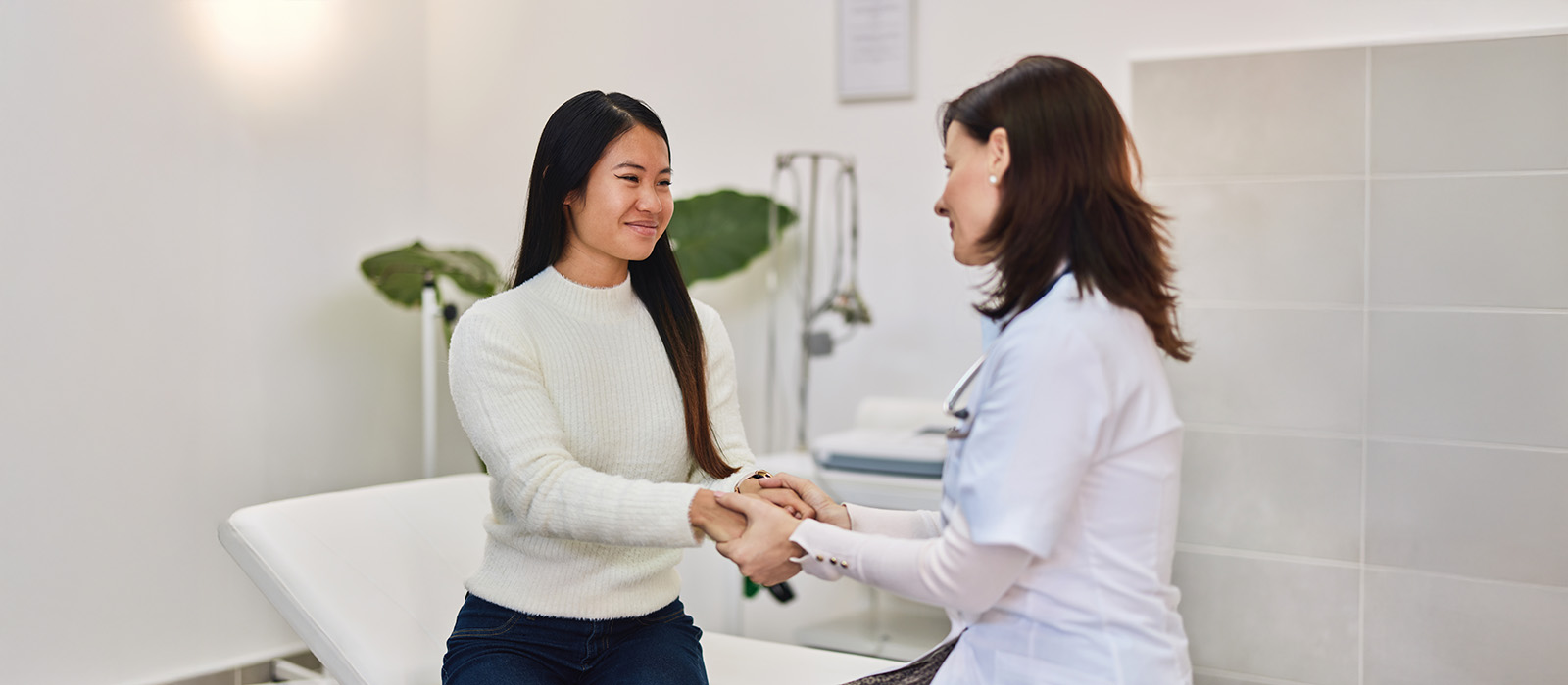 healthcare worker greeting female patient