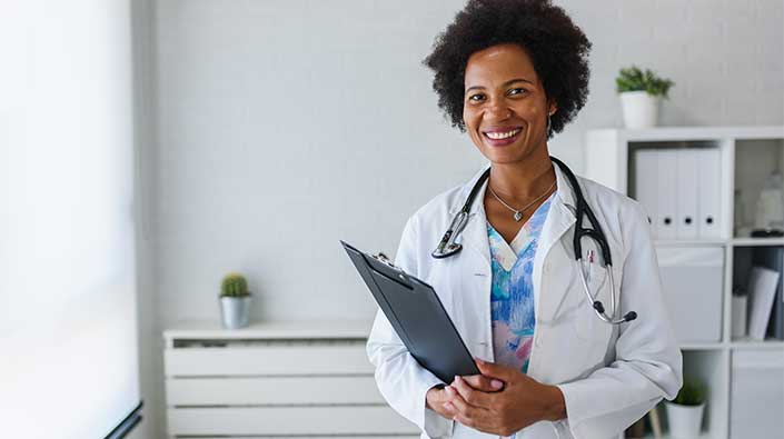 a female Black doctor with a welcoming smile