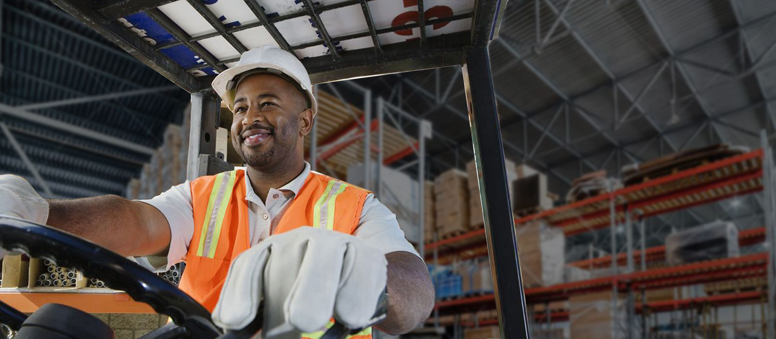 Warehouse worker driving lift.