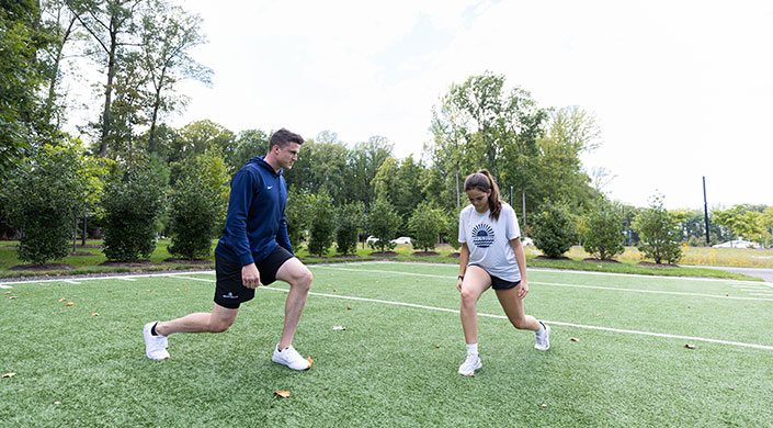 Two individuals exercising in a park
