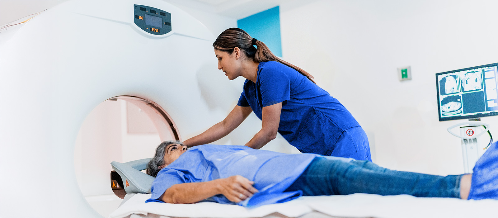 Young female image tech positioning patient