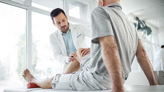 Doctor examining patient's knee