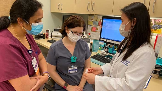 3 professionals discussing a treatment
